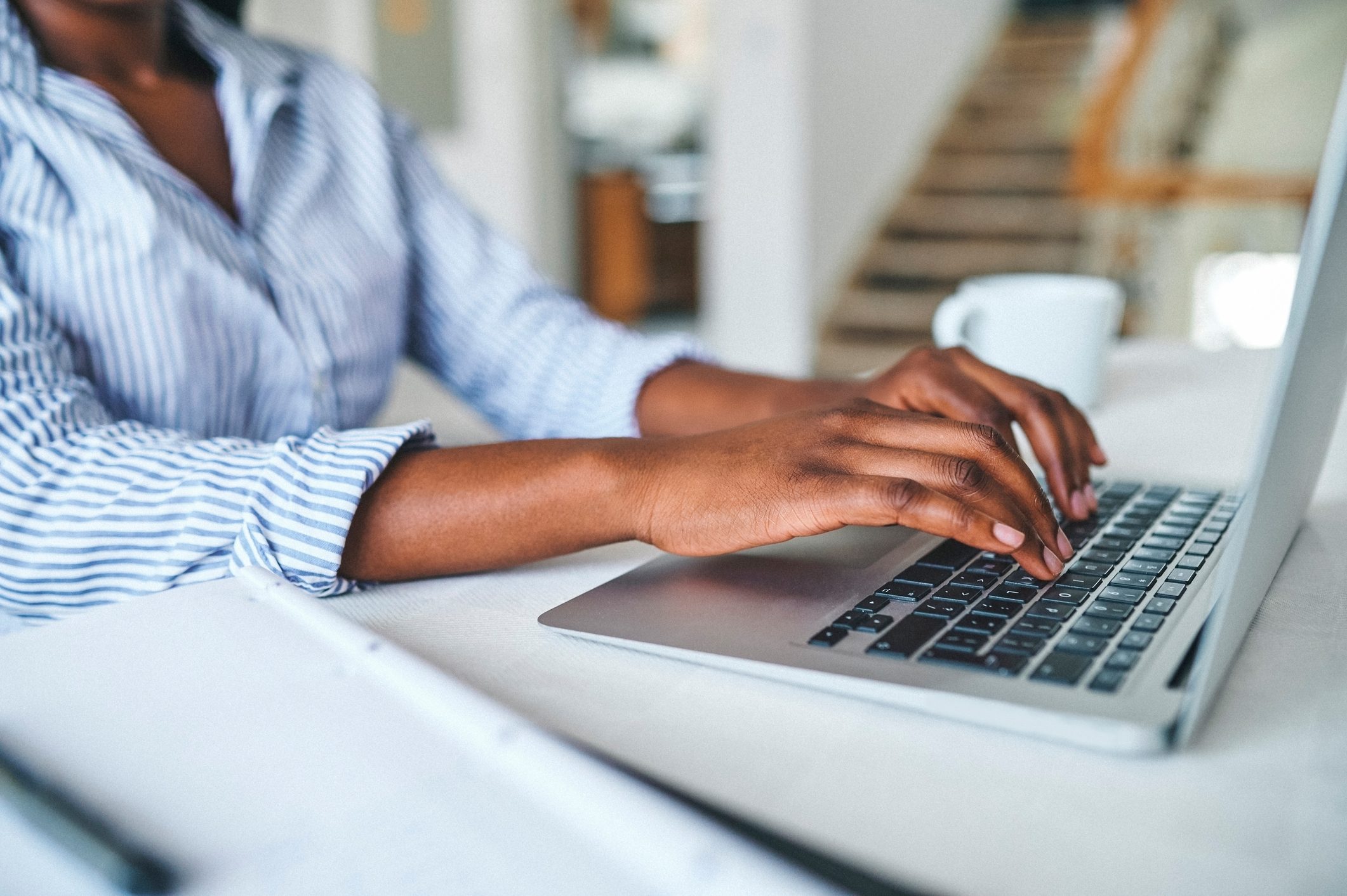 hands typing on a laptop and researching