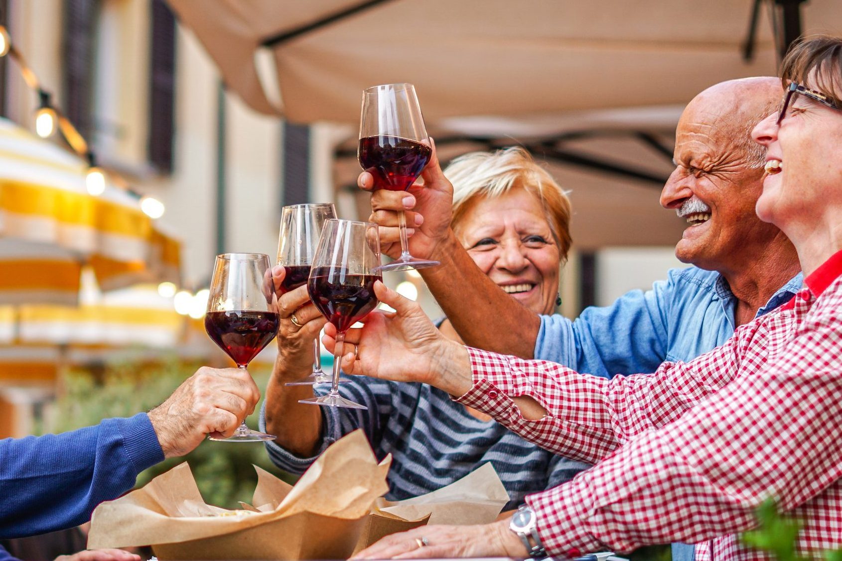 Group of old people eating and drinking outdoor