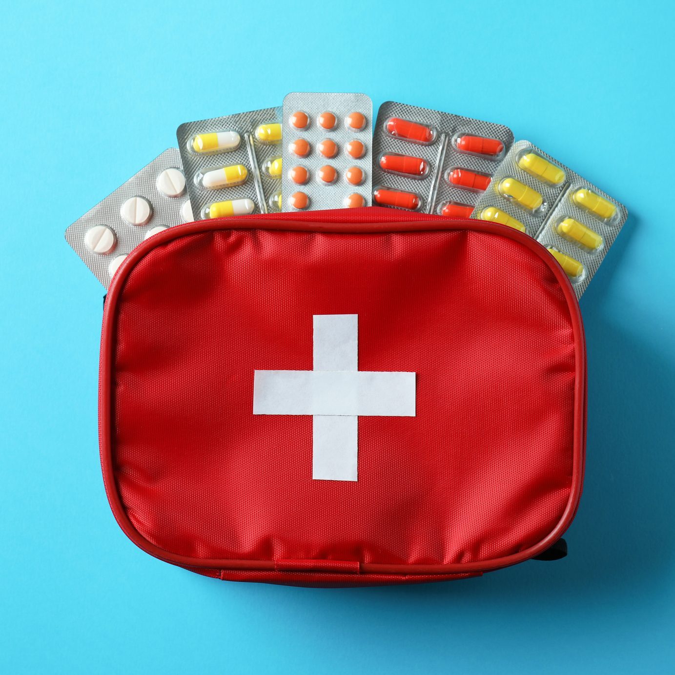 First aid medical kit on blue background