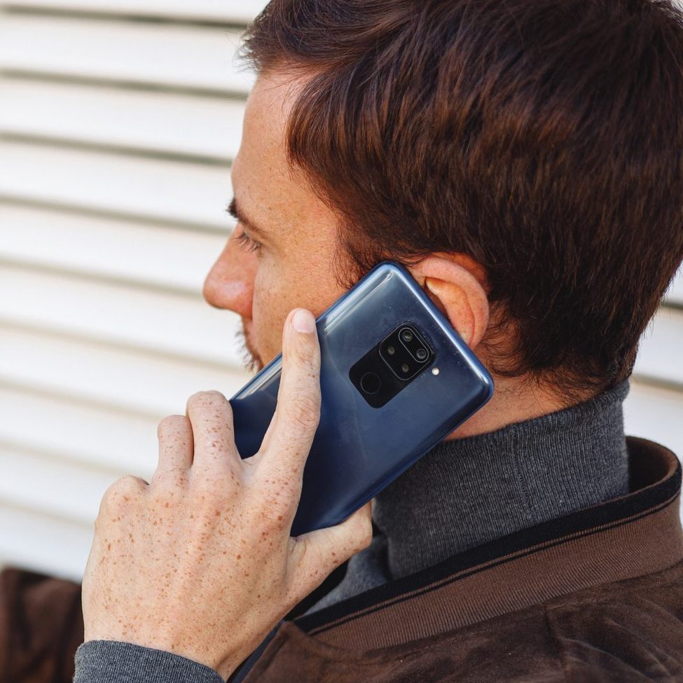 man talking on the phone while at the doctors