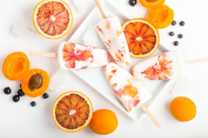 top view of a healthy homemade summer popsicle snack of frozen greek yogurt mixed with fresh fruit