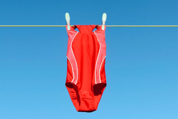 red swim suit hanging o na clothes line in the summer