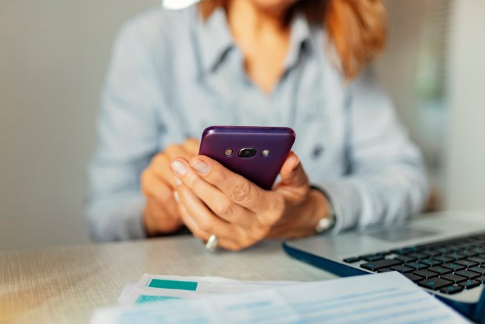 Close up of women's hands holding smartphone