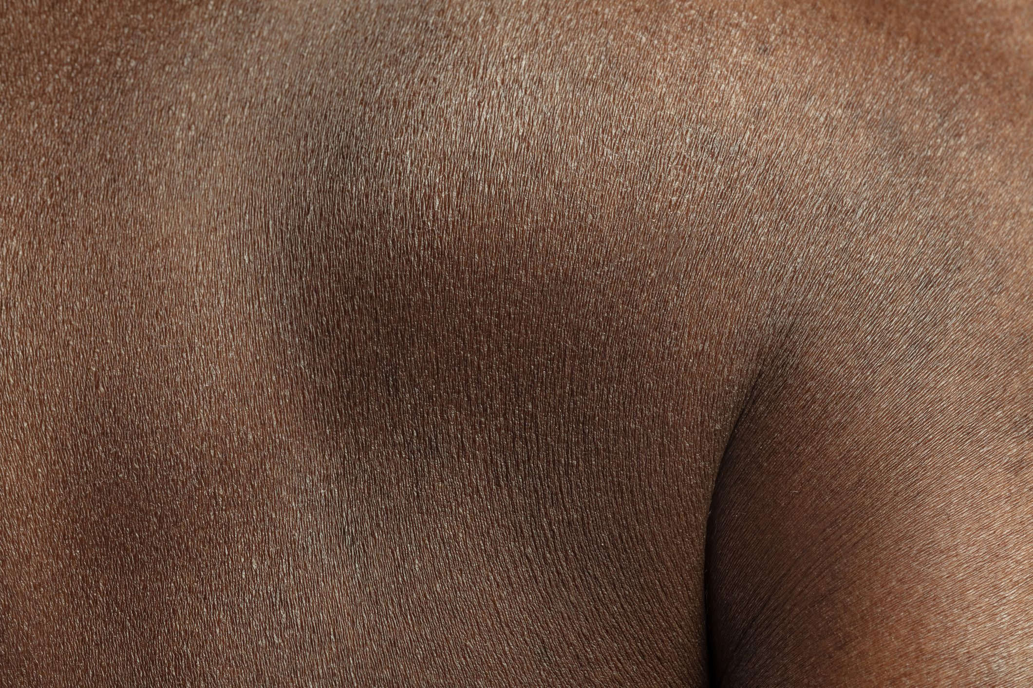 Texture of human skin. Close up of african-american male body