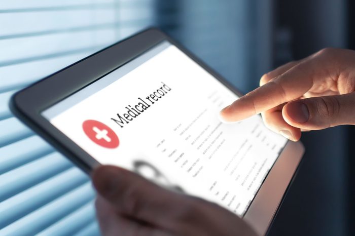 Medical record in electronic form. Digital EMR with patient health care information. Doctor using tablet in hospital or clinic. Personal data in mobile device.