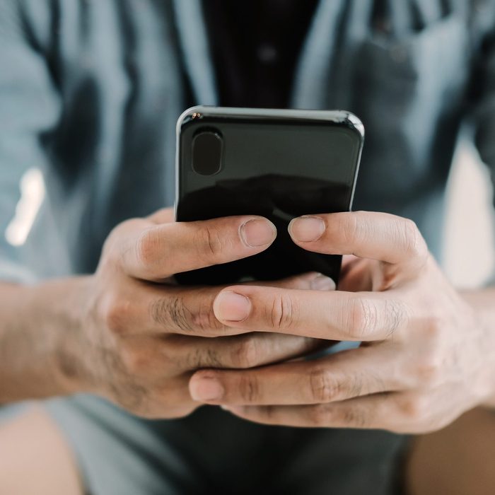 Close up man using smart phone