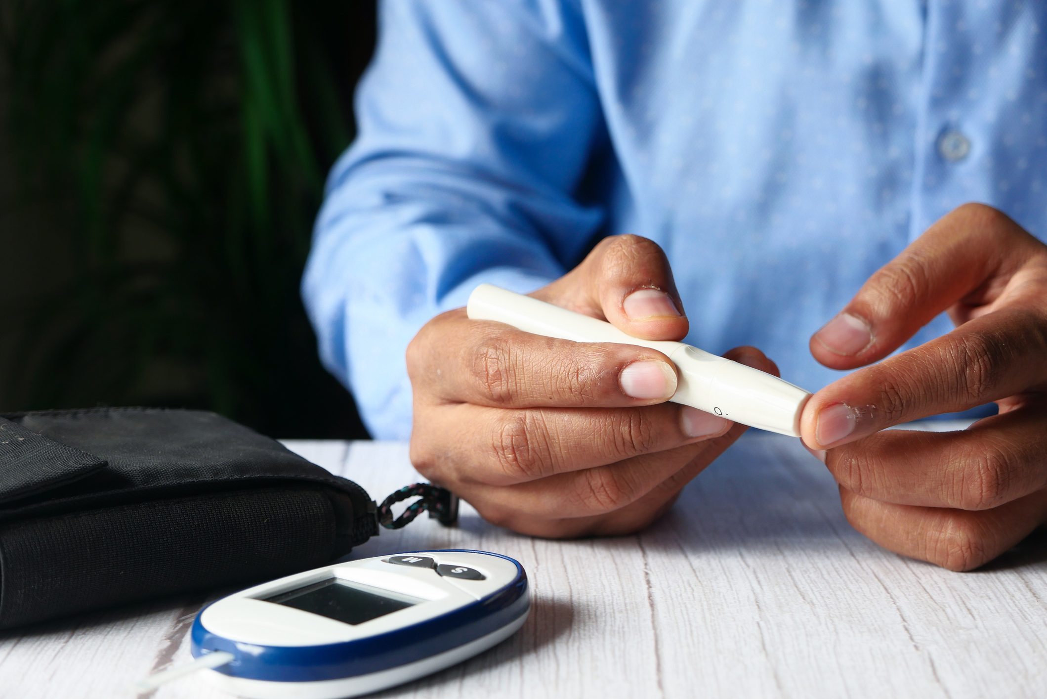 young man hand measuring diabetic on table