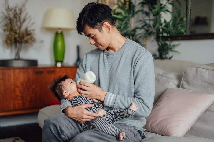 Father Feeding baby with baby bottle