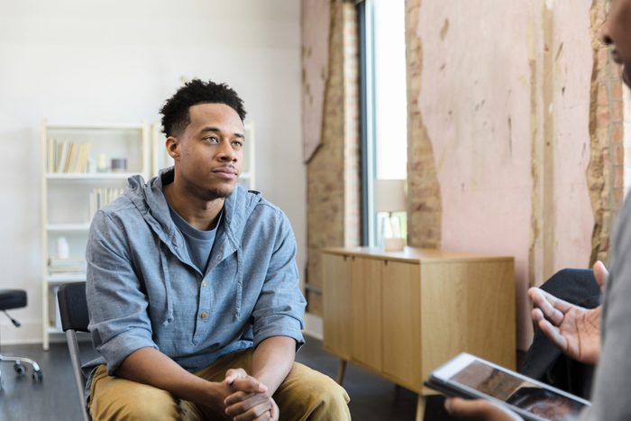 Young adult male listens to his therapist