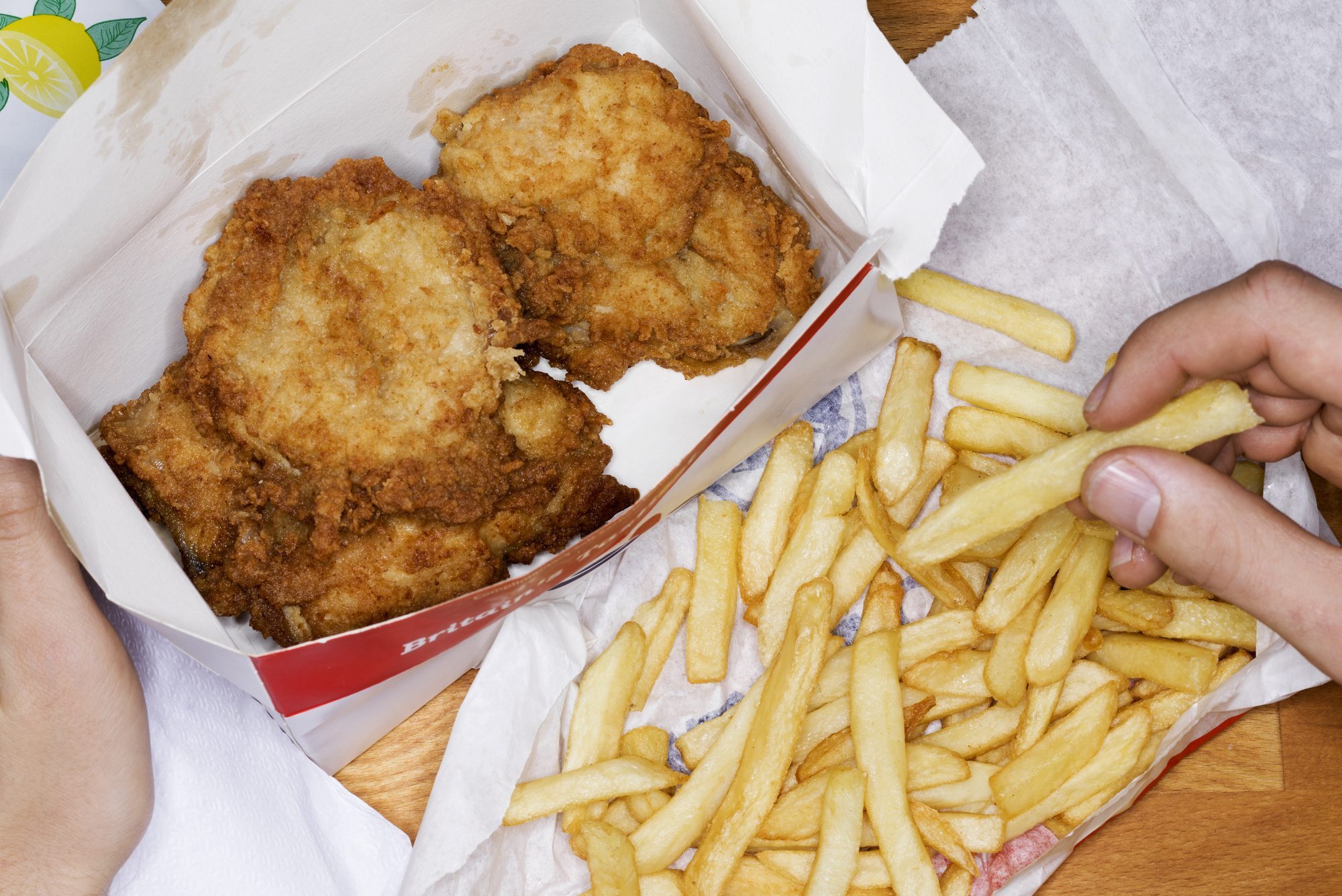 Men eating fast food, fries chicken and fries