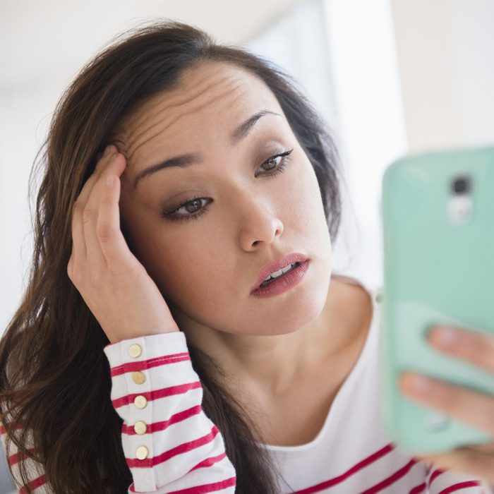 Stressed woman using cell phone