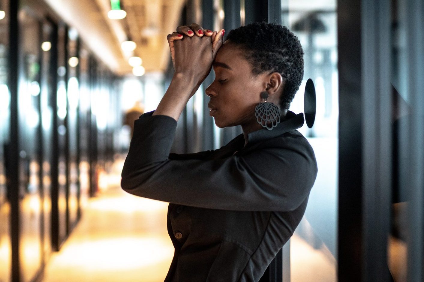 Worried young business woman at corridor office