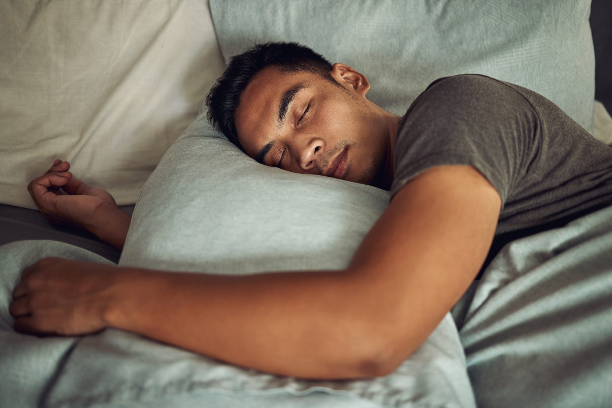 Shot of a young man sleeping peacefully in bed at home