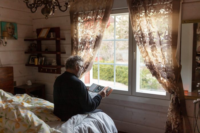 Senior man looking at old photographs