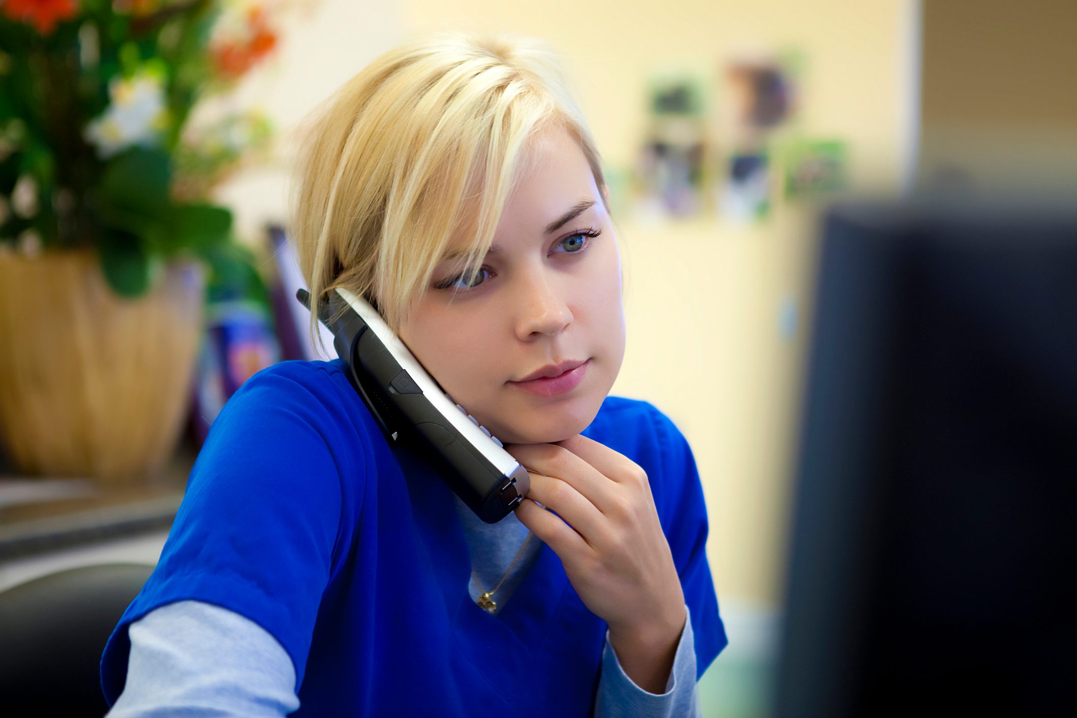 Medical Technician on Phone at Computer