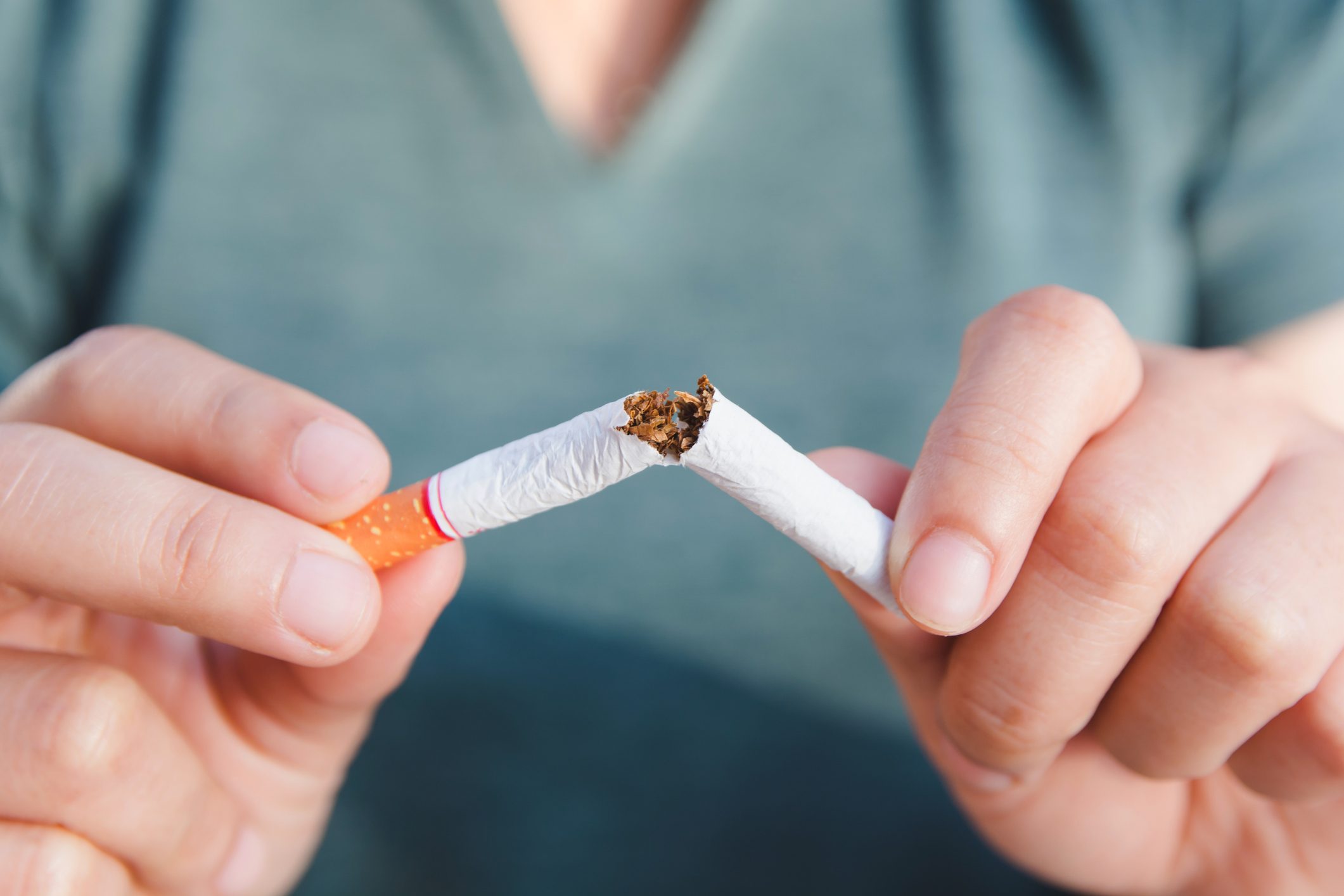 Stop cigarette, woman hands breaking the cigarette