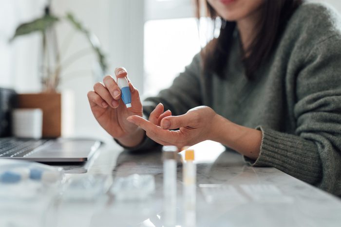 Cropped Shot Of Young Woman Doing Finger-prink Blood Test At Home