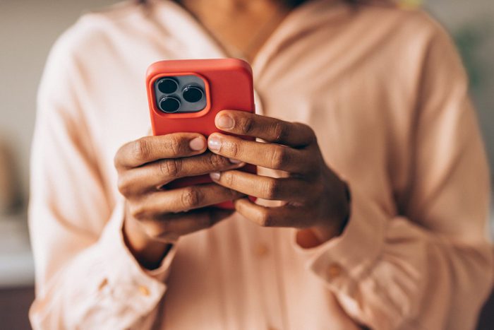 An Unrecognizable Happy Beautiful Businesswoman Using Her Mobile Phone
