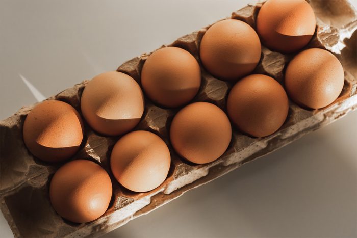 Carton container box with brown chicken eggs