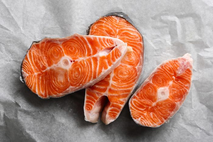 Cuts of salmon on paper