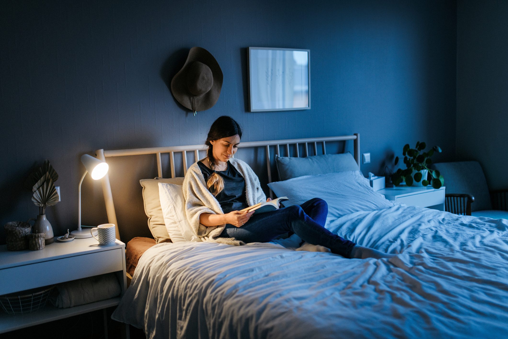 Woman reading a book at night