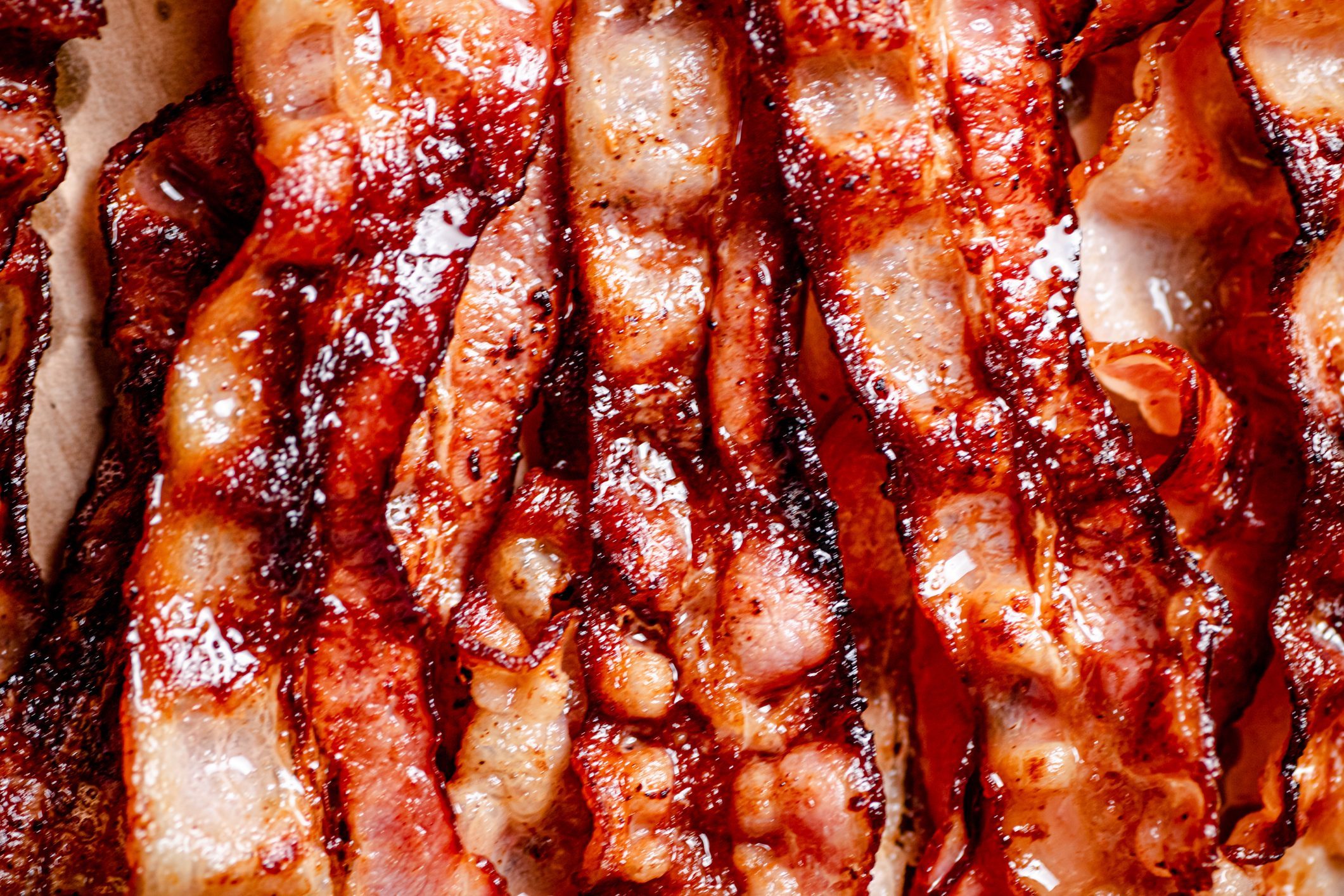 Strips of fragrant fried bacon. Macro background.