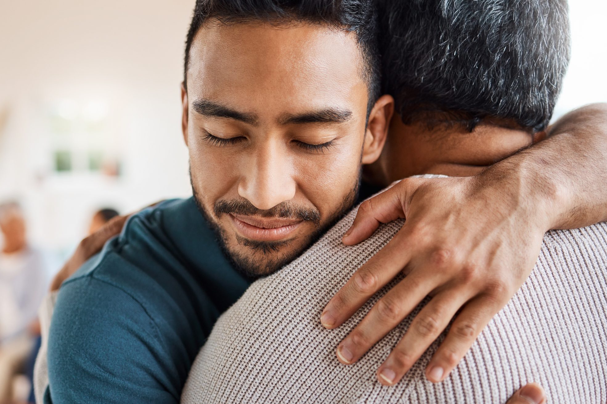 Shot of a father and son hugging at home