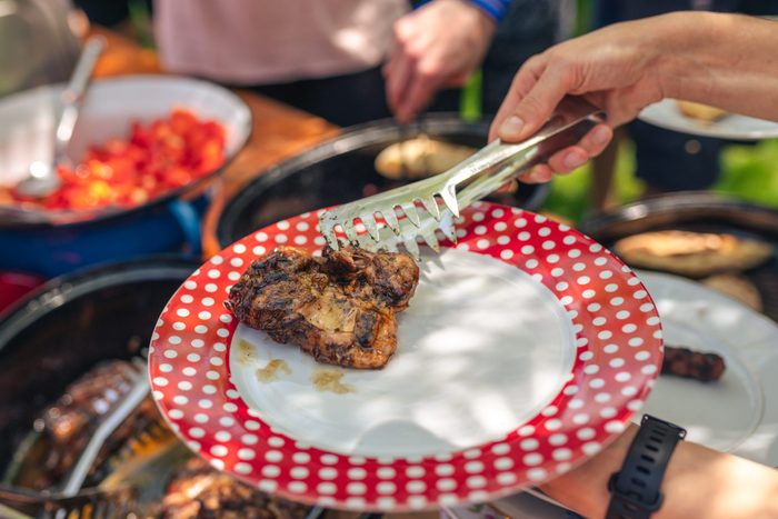 Serving food at neighborhood BBQ