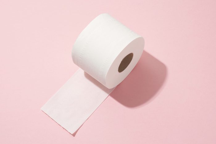 Toilet paper roll on pink background