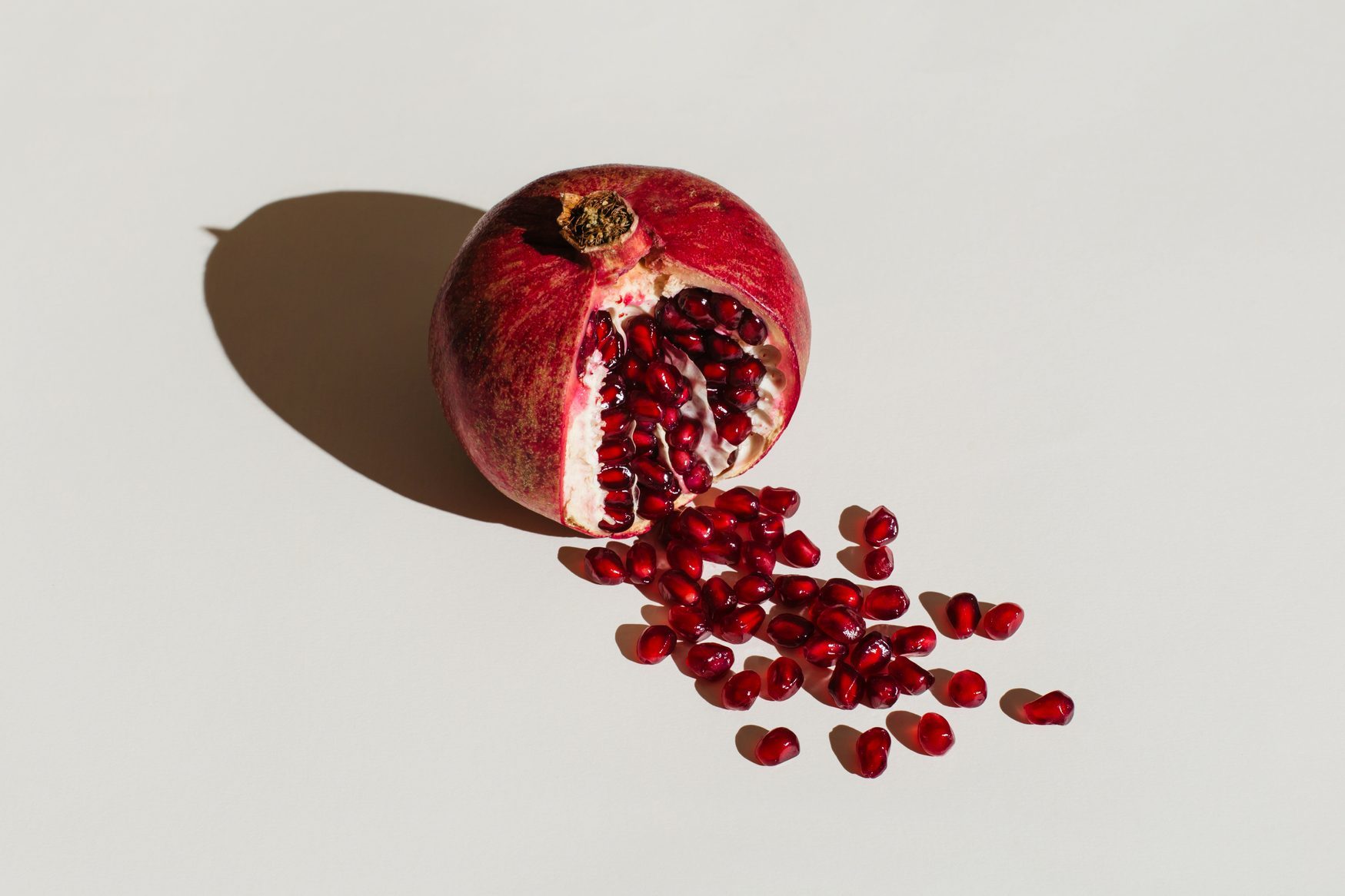 ut pomegranate on a white background. Menstruation concept. Symbol of vagina. Gynecology, female intimate health