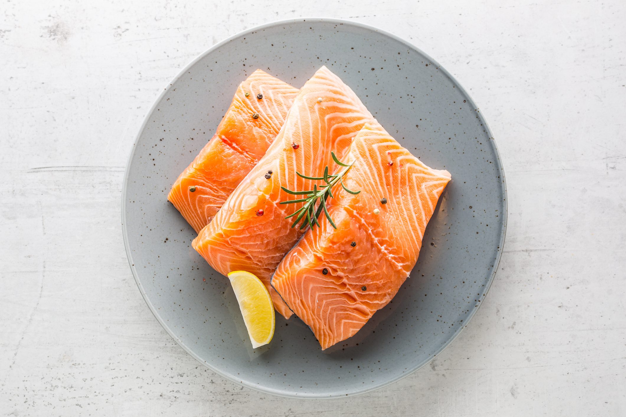 Salmon. Raw salmon steaks herb peper lemon on white concrete background