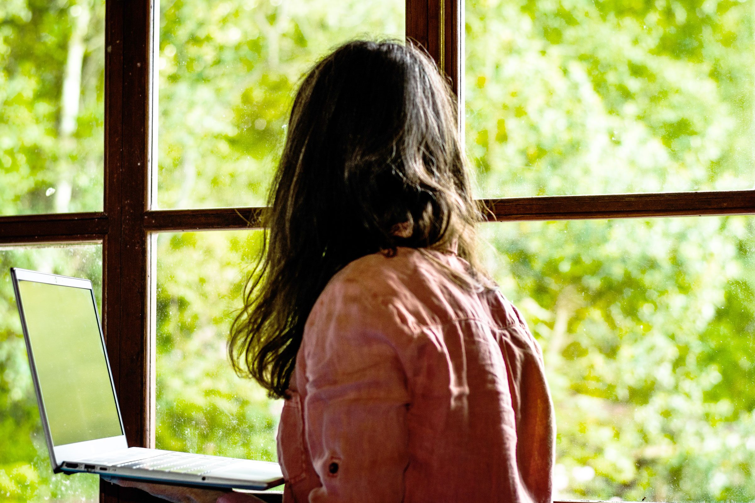 woman looking out the window