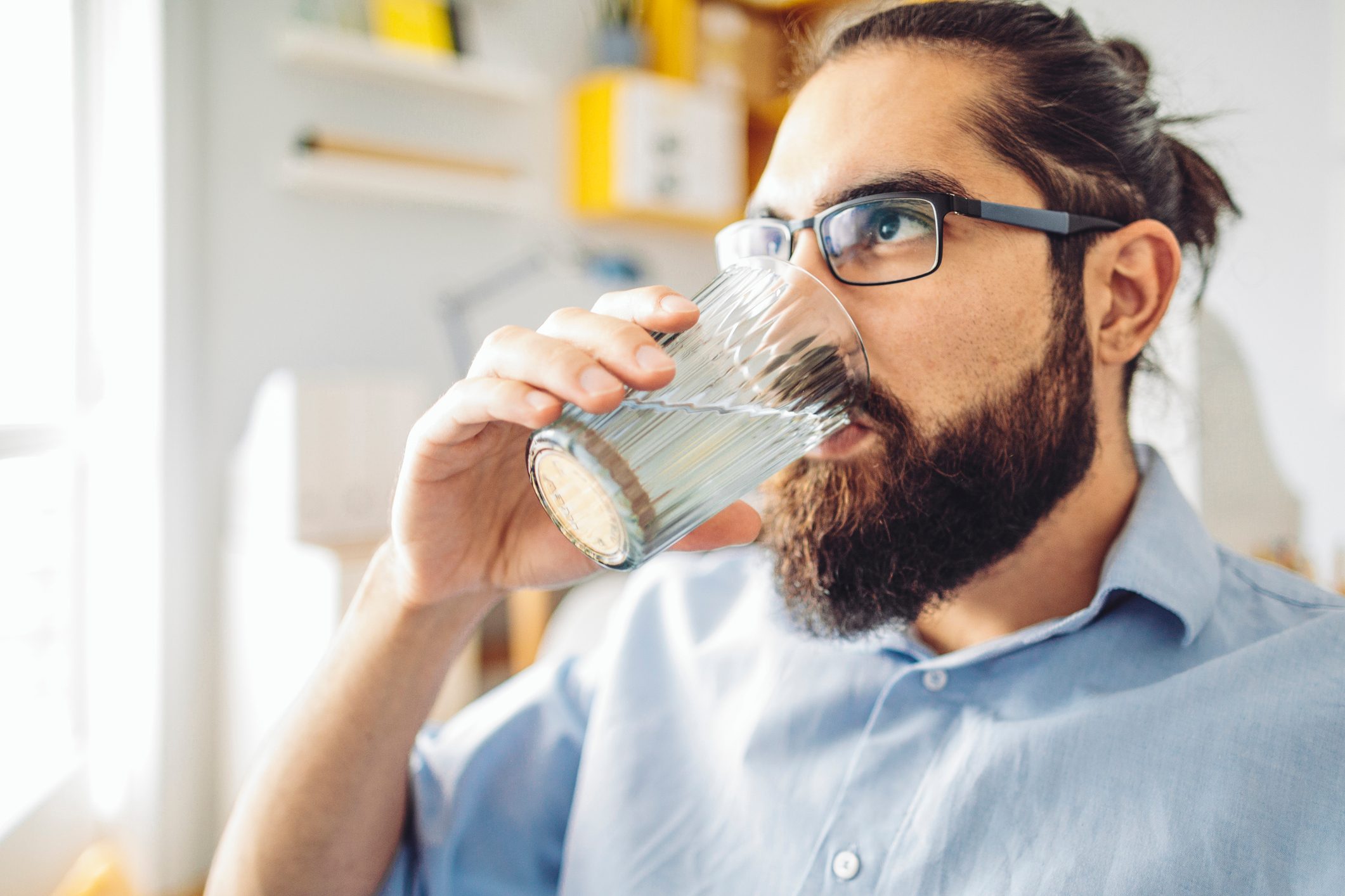 Man Drinking water at home