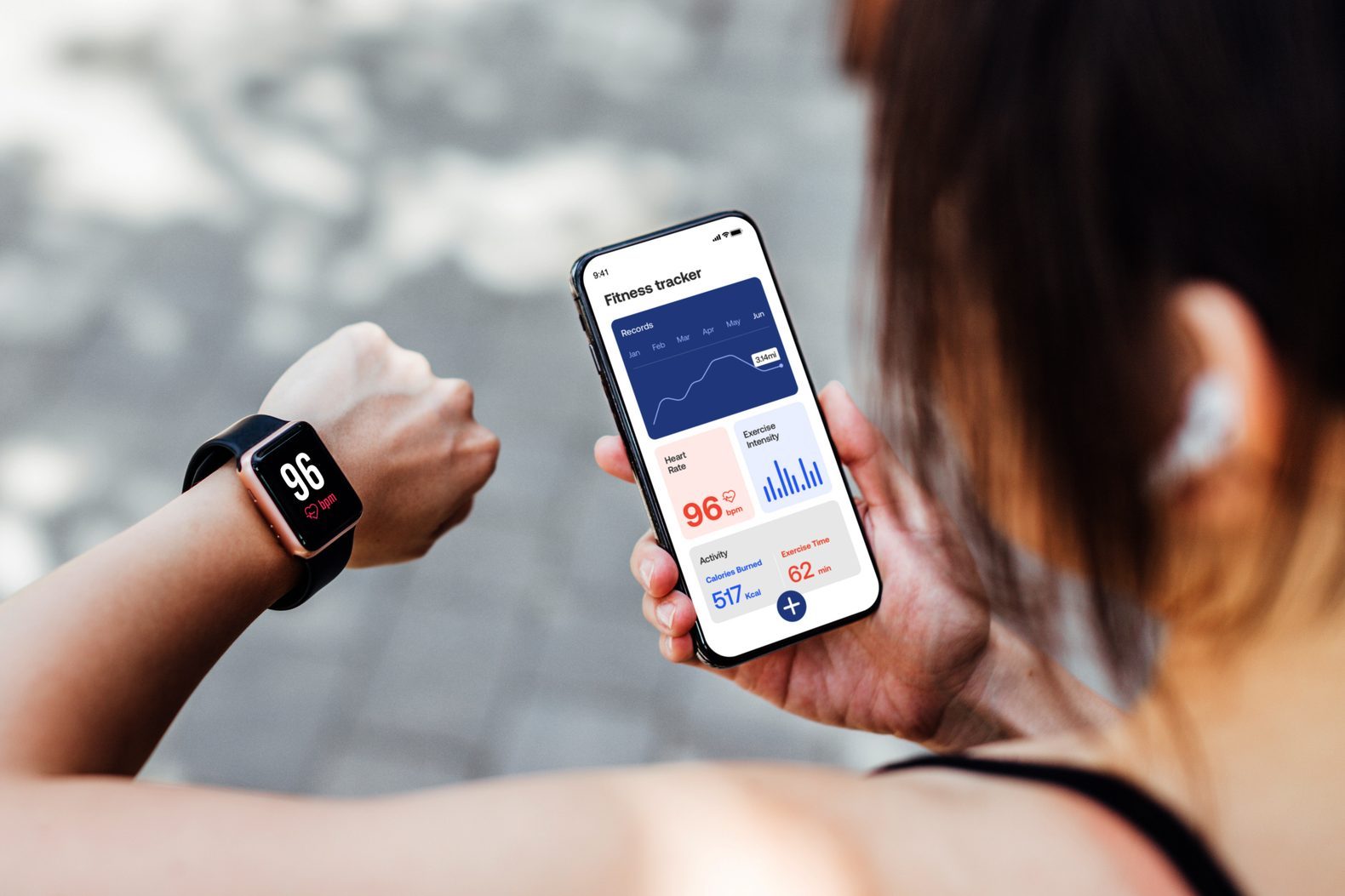 Young Woman Using Fitness Tracker App On Smart Watch And Smartphone