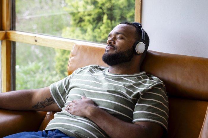man listening to music and sitting with eyes closed