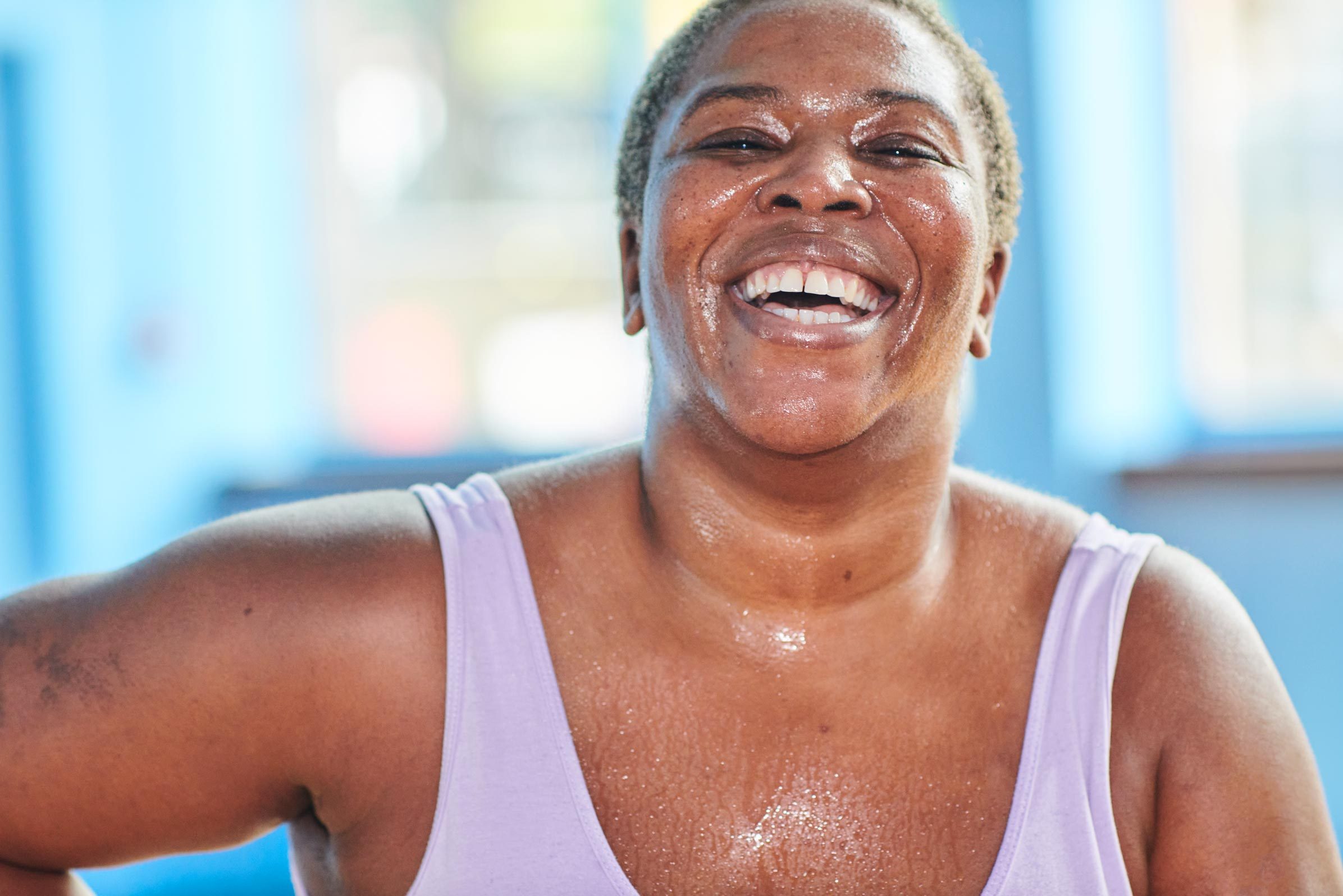 smiling woman sweating while exercising