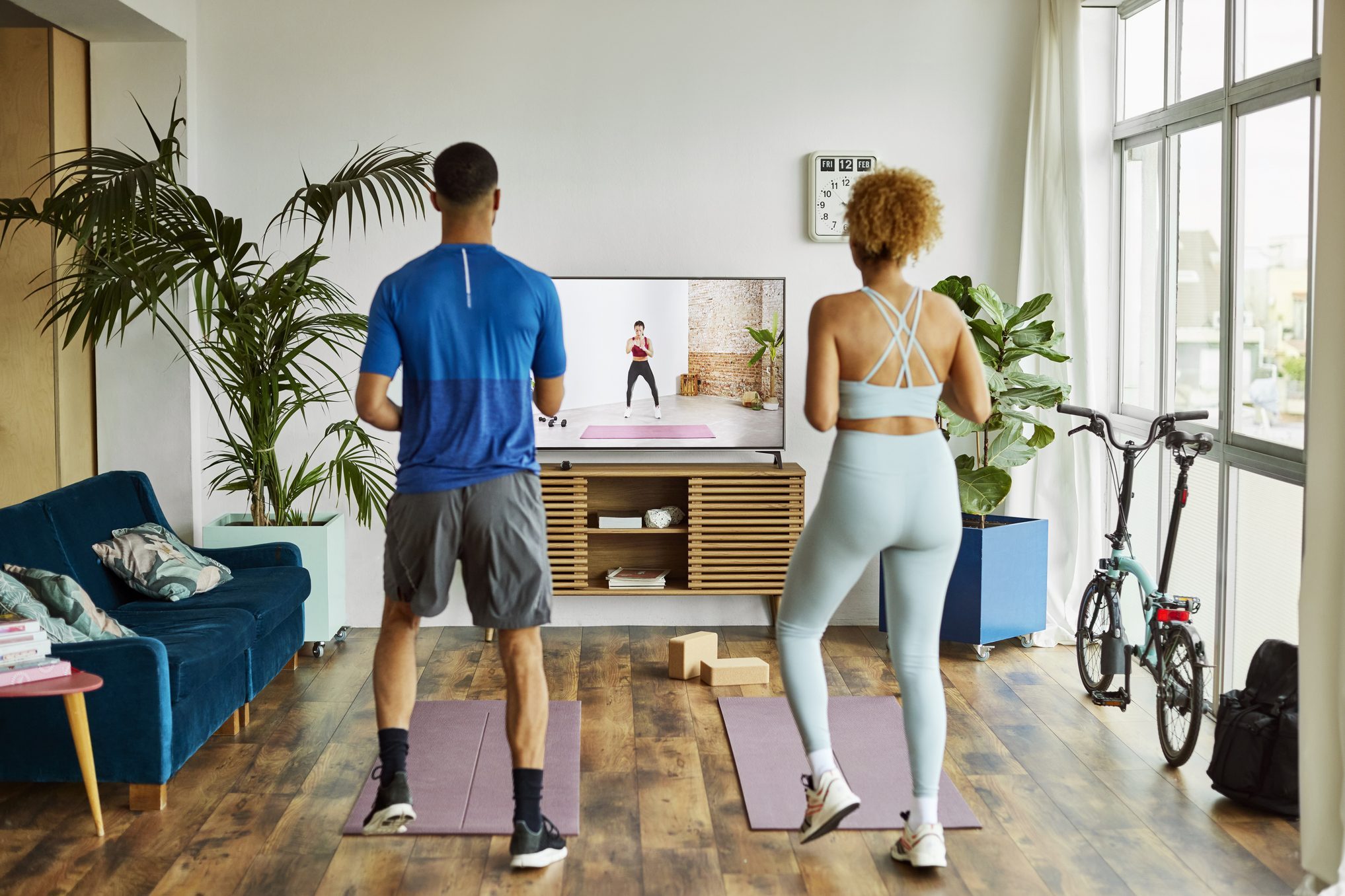 Couple Watching Online Exercise Class At Home
