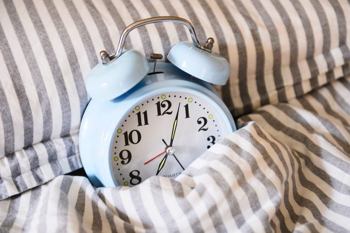 Blue arlam clock in bed