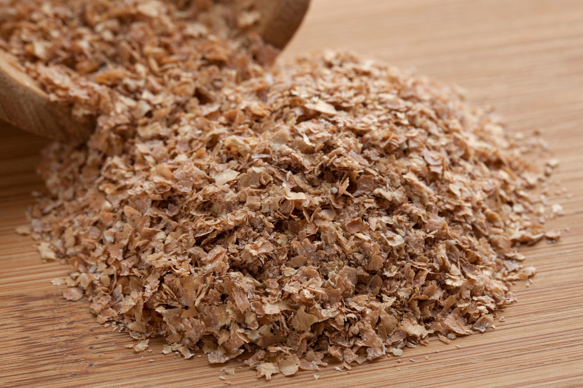 Wheat BranWheat bran with kitchen equipment photographed on plank