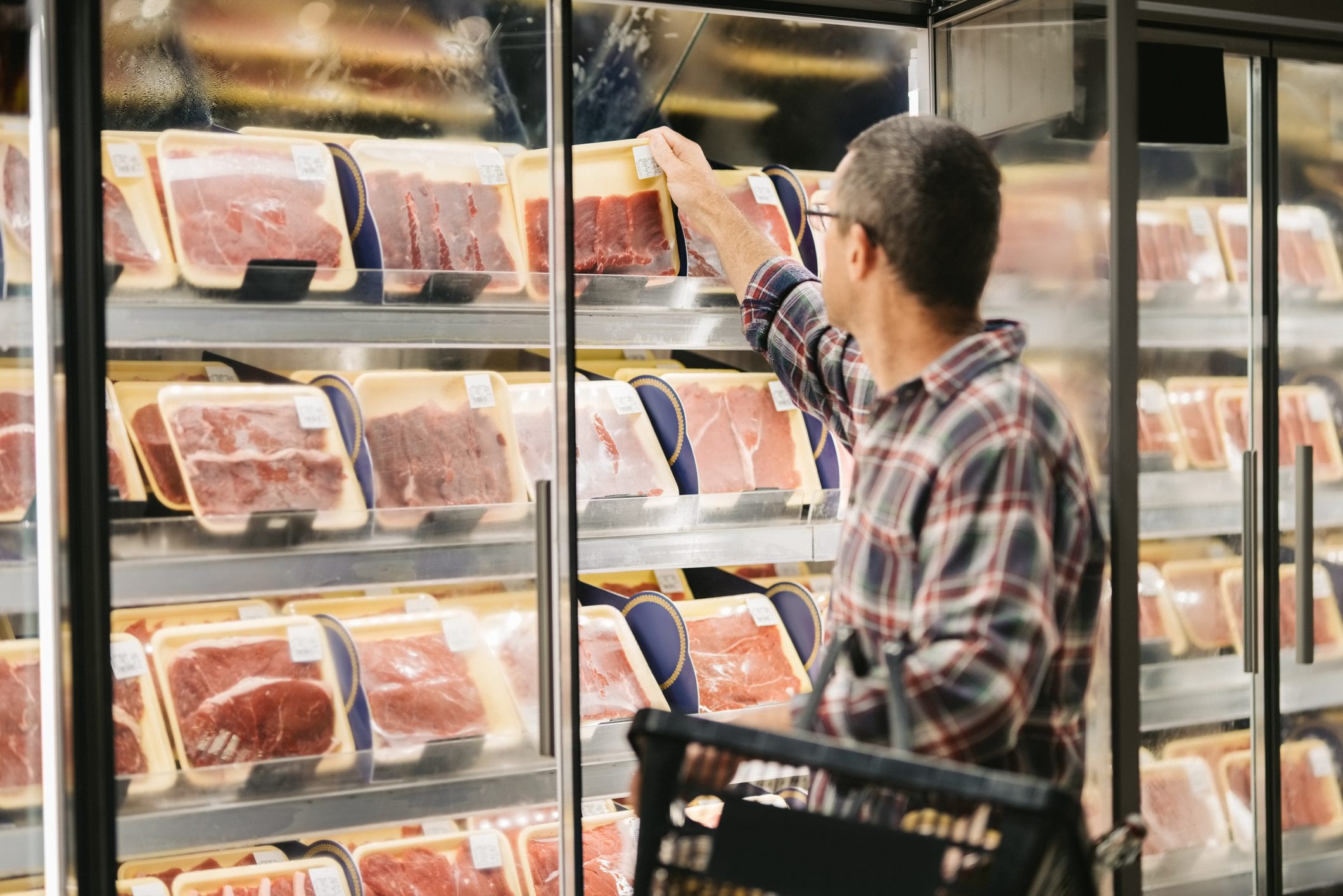 Man buying meat at grocery store