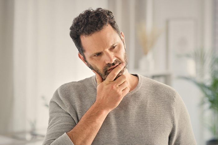 Home, doubt and man with stress, thinking and morning with depression, tired and brain fog. Apartment, burnout and person with anxiety, confused and fatigue with mental health and exhausted in lounge