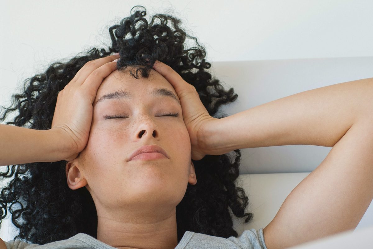 woman holding her head