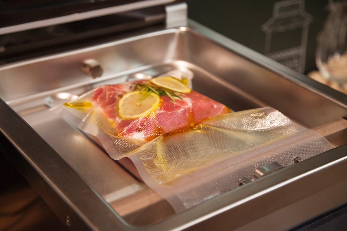 Beefsteak in olive oil with rosemary and lemon in vacuumed package