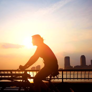 Commuter Cycling To Work In The Morning.